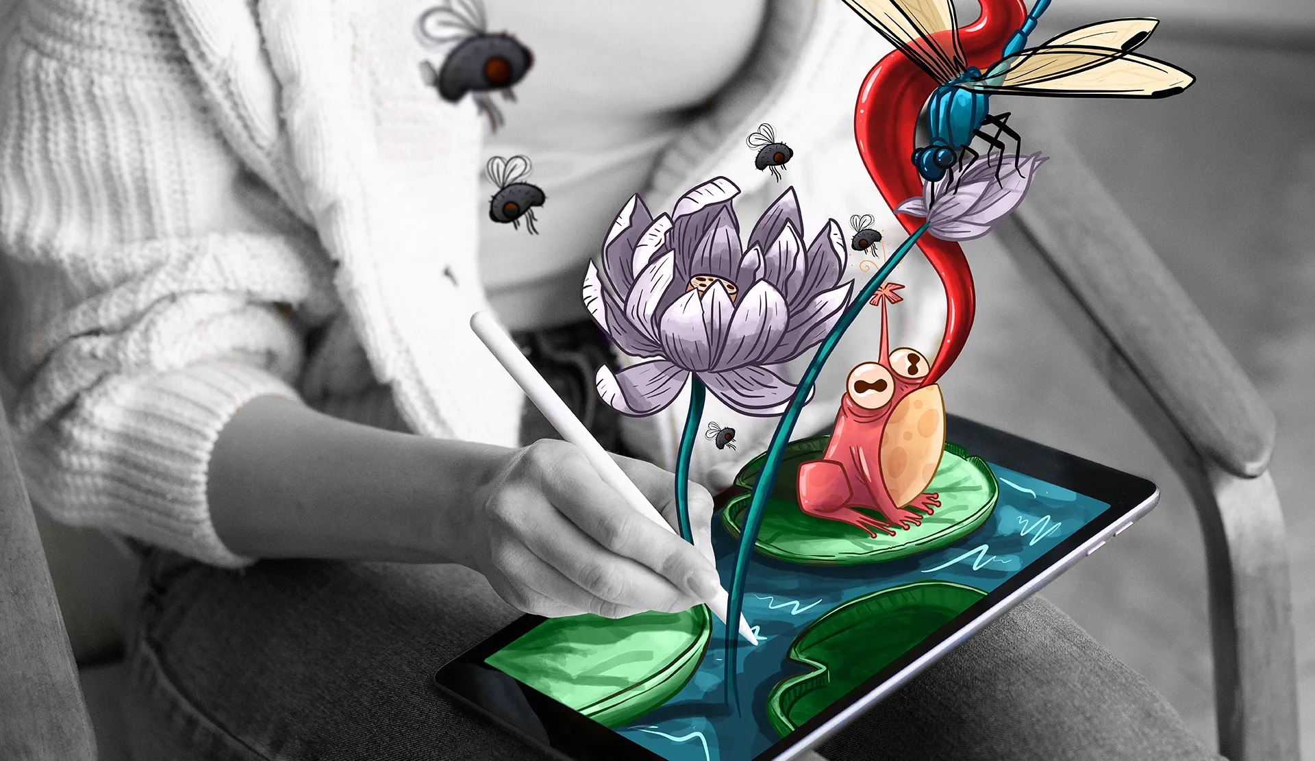 Person in black and white drawing on a tablet with a stylus, with imaginative 3D colored illustrations of flowers, insects, and a frog emerging from the screen, giving a sense of interactive creativity.